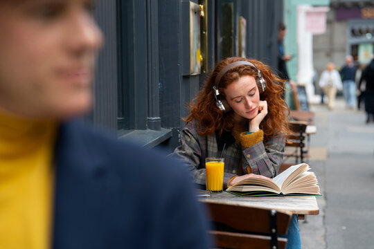 Woman reading book at cafe