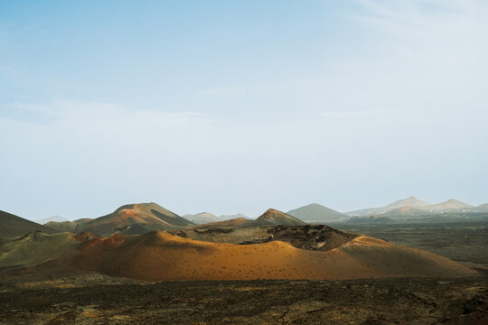 Dunes and mountains show colors in landscape during daylight