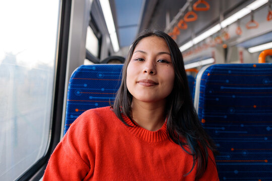 Woman looking at camera on train