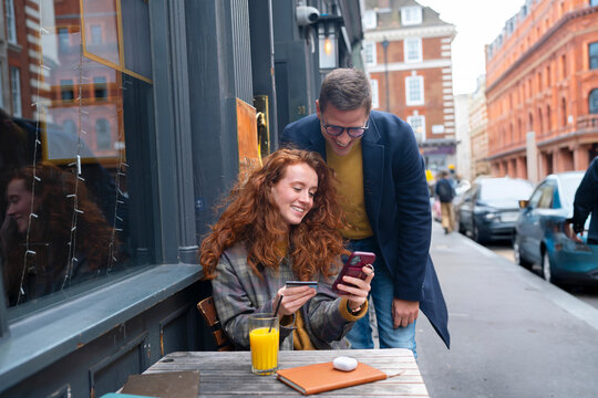 Sharing something on smartphone at London pub
