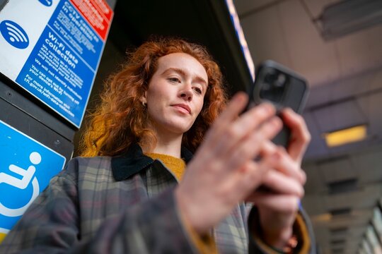 Using smartphone at London bus stop