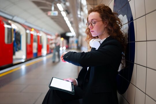 Woman checking time on subway platform