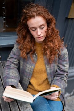 Woman reading book portrait outdoors