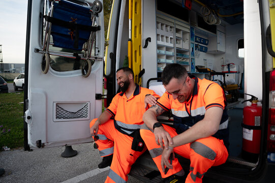 Paramedics laughing while resting