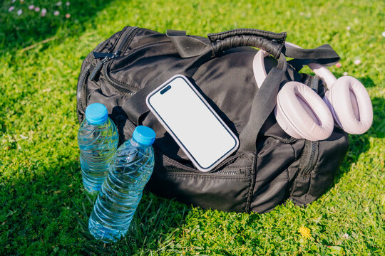 A mobile phone with white screen on a sports bag