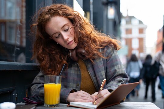 Writing notes at outdoor London pub table
