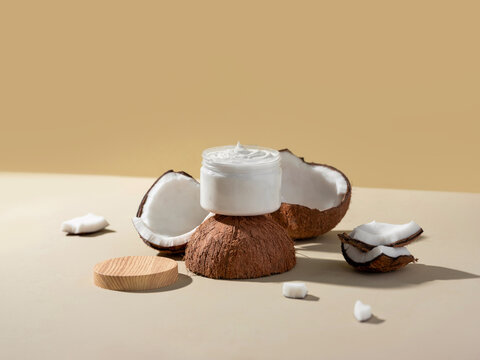 Coconut cream jar surrounded by coconut halves