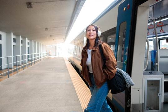 Woman getting off the train in station