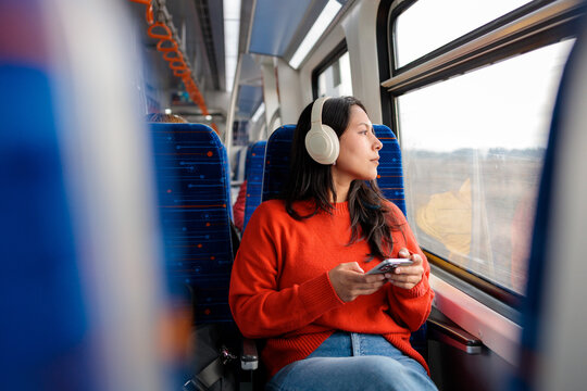 Woman looking out train window