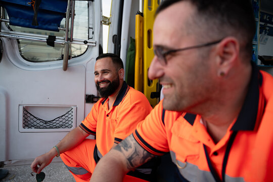 Paramedics laughing while resting