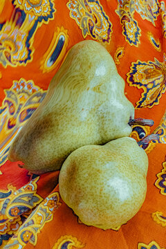 Pears placed on a colorful fabric surface