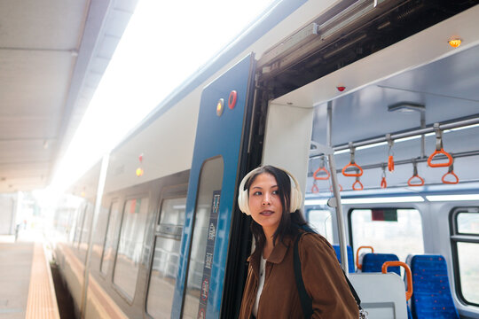 Woman exiting a train car