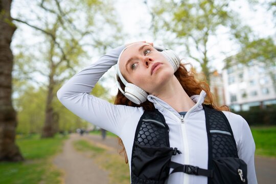 Woman stretching neck during outdoor workout