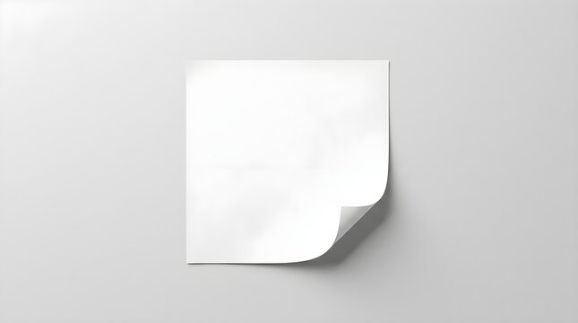 Blank sheet of paper with a curved corner casting a subtle shadow presenting an empty canvas for notes reminders or creative ideas on a light colored surface perfect for messages and