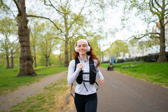Smiling woman running in park