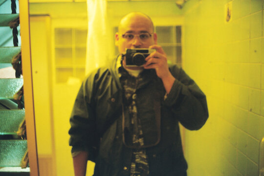 Mirror Self Portrait with Analog Camera in Yellow Bathroom