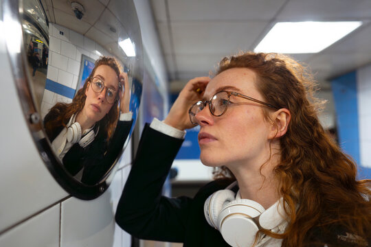 Commuter adjusting her hair