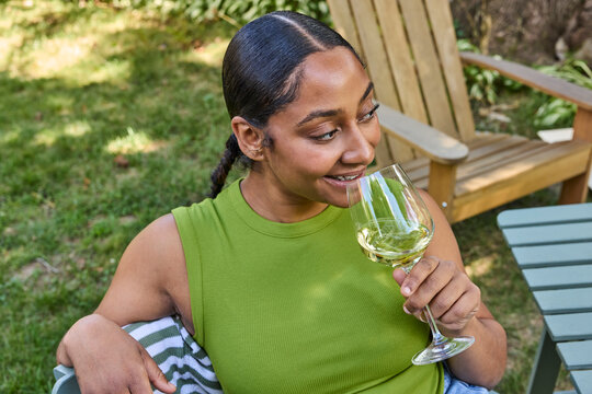 Woman drinking white wine outside