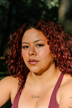 Empowered woman looking directly at the camera posing in athletic wear