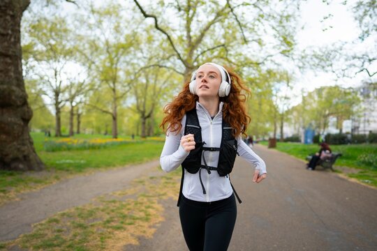 Woman jogging through park in London