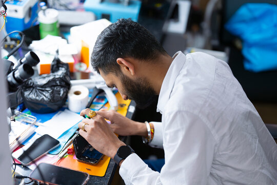 Technician focused on phone repair work