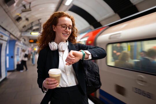 Smiling while checking time on platform