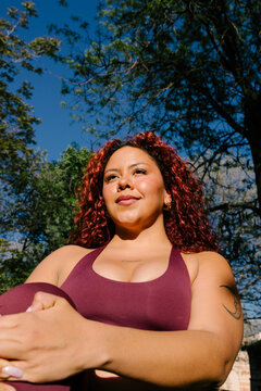 Athletic woman with a realistic body shape performs leg stretches