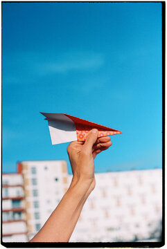 a man is about to throw a paper airplane into the sky, 35mm film