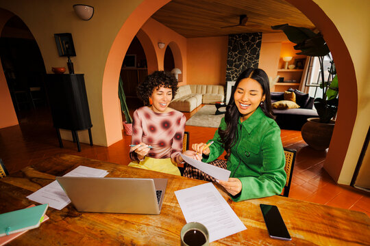 Women collaborating on business project in shared workspace