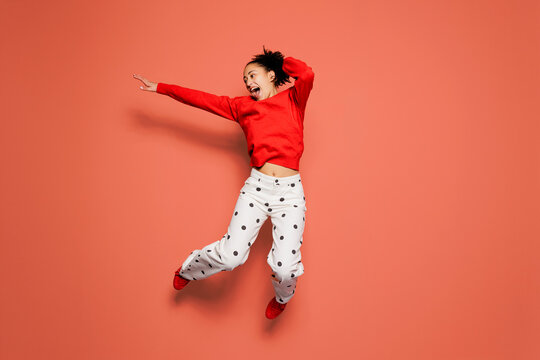 Woman jumping in air with excitement and joy