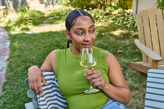 Woman drinking white wine outside