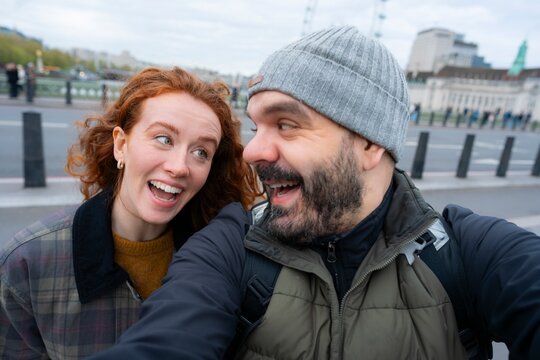 Laughing couple selfie in London