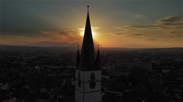 Aerial sunset 4k video of the Great Square in Sibiu, showing historic buildings, the Catholic and Lutheran Church, and the council tower, sunset landscape. Sibiu Transylvania landmarks. Romania video