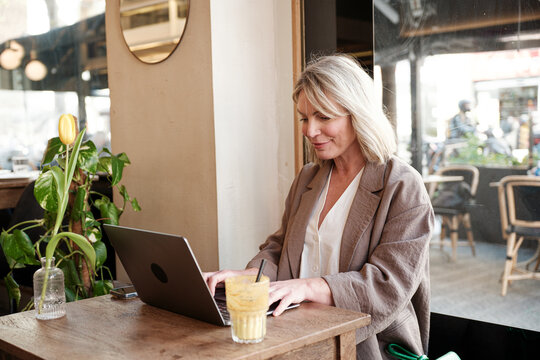 Woman using laptop at a cafe