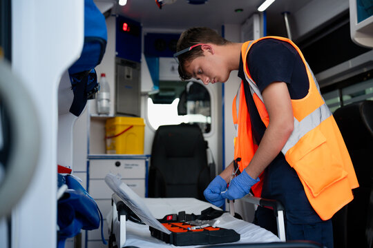 Paramedic preparing medical equipment