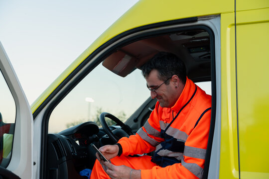 Paramedic checking phone