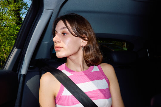 Woman looking out of the car window while traveling