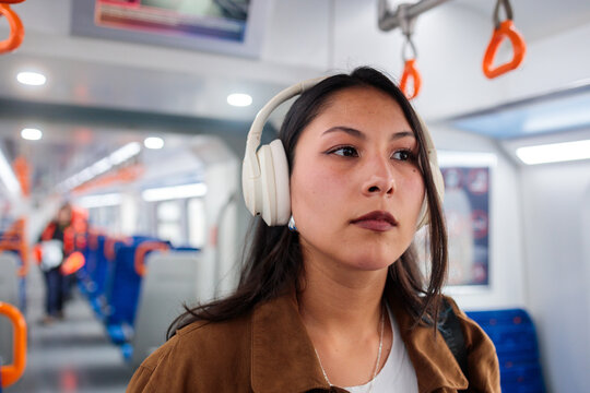 Woman with headphones on train