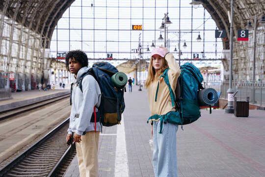 Backpackers at railway station before journey