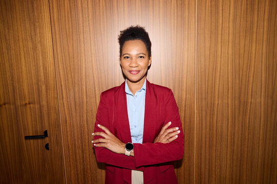 Elegant woman pose for a photo against wooden wall