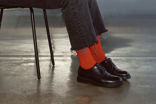 Woman wears black boots with red socks