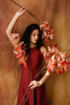 Woman holding autumn foliage 