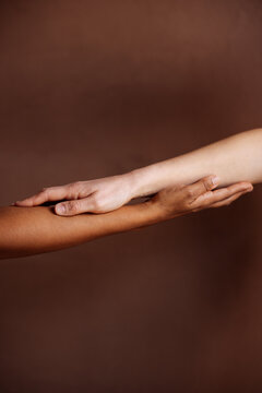 Interracial Hands Touching in Unity and Support
