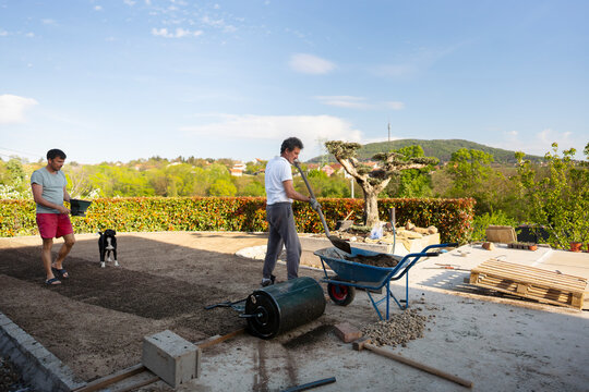 Preparing backyard soil with tools and teamwork
