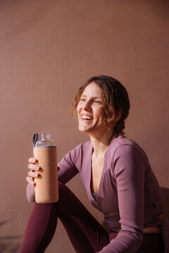 Happy Woman Resting After Workout With Water Bottle