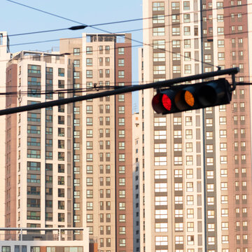 Sunset cityscape with traffic signals behind residential apartments
