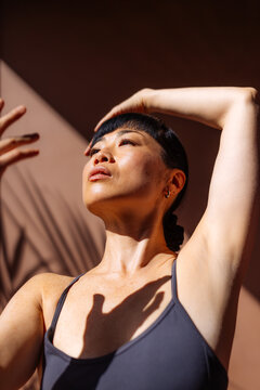 Woman Practicing Yoga Stretching Pose in Sunlight