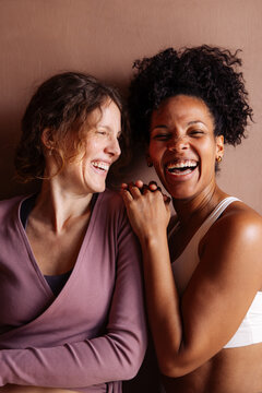 Two Women Laughing Together In Warm Friendship