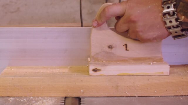 Woodwork safety. Joiner work. Male hand processing wood on thickness planer electrical professional machine. Powerful timber industry tool.