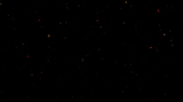 Floating vibrant orange and red dust particles slowly move creating a subtle atmospheric background